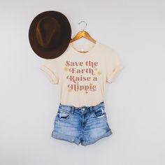 Women's Save The Earth Raise a Hippie Graphic Tee is perfect for Earth Day and beyond! Great new neutral design for spring and summer. Makes a great gift for your like minded friends and family! Dark shirt colors here: https://www.etsy.com/listing/970805330/womens-save-the-earth-raise-a-hippie?ref=shop_home_active_1&frs=1 Looking for more vintage/retro inspired tops and tees? Check these out: https://www.etsy.com/shop/TheGraphicPeach?ref=seller-platform-mcnav&section_id=33890848 Our shop Spring Graphic Tee Shirt With Funny Text, Spring Cotton Shirt With Funny Text, Love Your Mother Earth, Vegan T Shirt, Love Your Mother, Minimalist Graphic Design, Save The Earth, Mother Shirts, Bella Canvas Tees