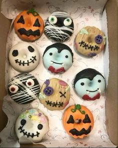 a box filled with lots of decorated donuts