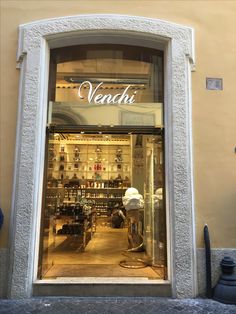 a store front with the words venchi written on it's glass door