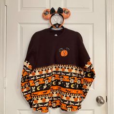 Set: Mickey Mouse Halloween Spirit Jersey Size Medium And Loungefly Disney Mickey And Minnie Spider Glow Ear Headband Materialize Your Spooky Side In This Restless Spirit Jersey With Glow-In-The-Dark Decoration. Puffy ''Boo'' Letters On The Back And Mickey's Pumpkin-Spiced Pattern Will Fix You Up For The Happiest Halloween Ever! Magic In The Details: Long Sleeve Pullover Top Puffy ''Boo!'' Letters On Back Shoulder And Puffy Decoration Glows-In-The-Dark All Sides Feature Mickey Mouse Halloween Pa Disney Apparel, Disney Ears Headband, Mouse Halloween, Disney Mickey And Minnie, Mickey Pumpkin, Mickey Mouse Halloween, Spirit Jersey, Cute Headbands, Loungefly Disney