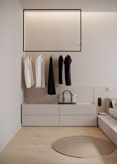 a white room with clothes hanging on the wall