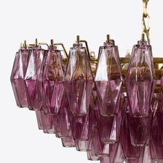 a chandelier with pink glass shades hanging from the ceiling