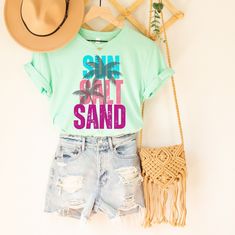 This cute and comfortable Sun Sand Salt T-Shirt is perfect for all you beach lovers out there Dip your toes in the sand and relax in this comfy and stylish shirt! Choose your color! The cotton material is flattering and perfect for layering so you can wear it all year long...whether you're on the beach or dreaming about it  Please refer to the sizing chart to find your perfect fit.  Great Gifts for: Milestone Birthday Gifts: 21st Birthday Gift, 30th Birthday Gift, 40th Birthday Gift etc Gifts Fo Milestone Birthday Gifts, 30th Birthday Gift, 21st Birthday Gifts, 30th Birthday Gifts, Gifts Fo, Milestone Birthday, 40th Birthday Gifts, Beach Shirt, Cute Shirt