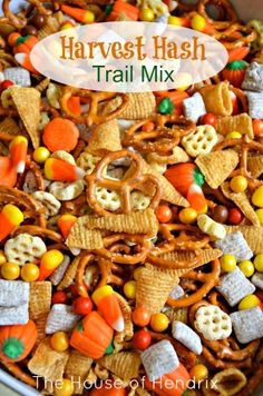 a bowl full of halloween themed trail mix with the words harvest hash above it in white lettering