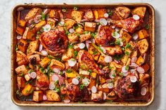 a pan filled with chicken and vegetables on top of a table