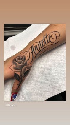 a woman's arm with an inked rose and the word annte on it