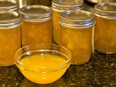 jars filled with yellow liquid sitting on top of a counter