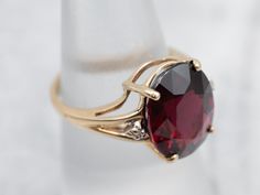 Absolutely gorgeous! This sleek yellow gold mounting required a good-sized stone to set complete, and we chose a truly high-quality garnet! The ring is really all about the center stone, and the simple styling and two accent diamonds create the perfect stage. The center stone is a gorgeous, very fine quality garnet, which is a beautiful crimson color with undertones of fire burgundy.Metal: 10K Yellow GoldGem: Garnet 7.95 CaratsGem Measurements: 10.6 x 13.5 mm, OvalAccents: 2 Diamonds totaling .01 Carats, H in Color, SI in ClarityRing Size: 6.50Marks: "10KA/(C)" Stamped on the inside band Vintage Garnet Ring, Crimson Color, Garnet Ring Vintage, Garnet And Diamond Ring, Garnet Jewelry, Garnet Ring, Three Stone Rings, Garnet Rings, Pearl Pendant