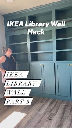 a woman standing in front of a bookcase with the words ikea library wall hack