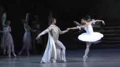 two ballerinas in white tutus and one is holding the other's hand