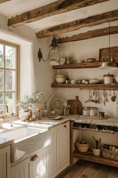 a kitchen filled with lots of wooden shelves next to a window