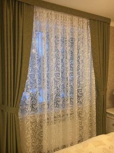 the curtains are hanging on the window sill in front of the bed and dresser