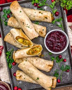 some food is laying out on a tray with cranberry sauce and condiments