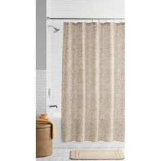 a shower curtain with a leopard print on it in a white and beige bathroom setting