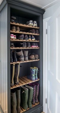 an open shoe rack with several pairs of boots