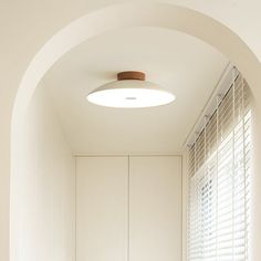 an arched doorway leads into a white bathroom