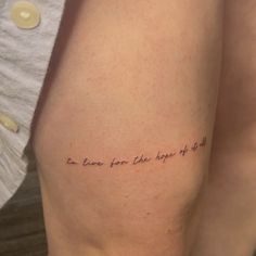 a woman's thigh with the words, one love from the hope of god written on it