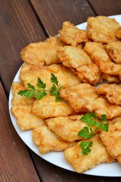 fried food on a white plate with parsley