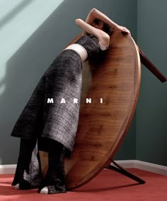 a woman leaning on a surfboard with the word mannequin written on it