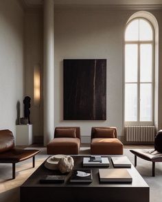 a living room filled with furniture and a painting on the wall