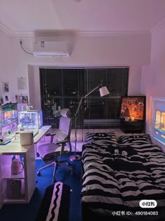 a bed room with a neatly made bed and two monitors