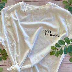 Share your greatest achievement with an everyday white tee dedicated to being a mama. This white T is the perfect shirt for running errands, hanging with your little ones, or celebrating being a mom with your mom squad. T-shirts are unisex sizing. Recommended washing instructions: Wash and dry garments inside out Wash with cold or warm water Use a mild detergent Tumble dry low or hang dry Do not iron directly on the design White Relaxed Fit T-shirt For Family Matching, White Letter Print T-shirt As Gift, White Letter Print T-shirt As A Gift, White T-shirt For Mother's Day Gift, White T-shirt With Letter Print For Mother's Day, White Graphic Tee With Custom Text, White Custom Text Short Sleeve T-shirt, White Short Sleeve T-shirt With Custom Text, White Text Print T-shirt As Gift