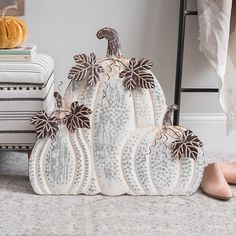 decorative white pumpkins sitting on the floor