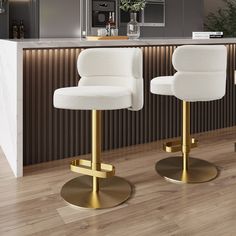 two white bar stools sitting in front of a counter