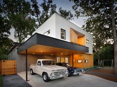 two trucks are parked in front of a house with a car attached to the garage