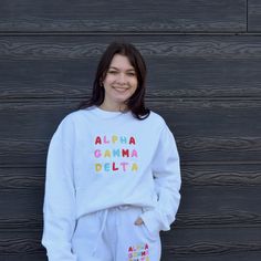 The dress code is optimistic with this bright and fun crew! So add a little happiness to your wardrobe and start loving your letters in this sorority essential. Pair this cute sweatshirt with the matching bright & fun tote bag or your favorite pair of jeans for a retro and classic style. Your sorority name will be embroidered in bright colors in stacked font. Model is wearing a size XL on top for an oversized fit. She is 5'6" a size 4/6, 34B. Crew is tucked in for most photos. Crewneck: 9 oz Loving You Letters, Sorority Names, Best Tote Bags, Alpha Gamma Delta, Cute Sweatshirts, 30 And Single, Woven Labels, Dress Code, Dress Codes