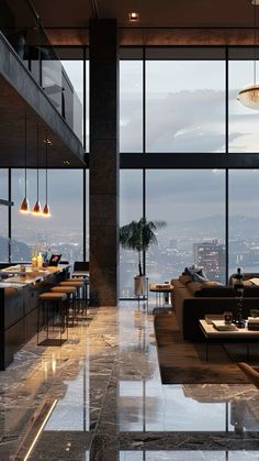 a living room filled with lots of furniture and large windows overlooking the cityscape