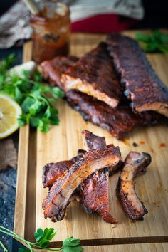 barbecue ribs on a cutting board with garnishes