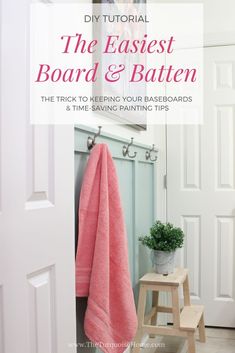 a pink towel sitting on top of a wooden step stool next to a white door