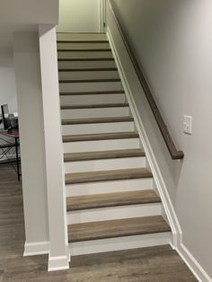 an empty room with stairs leading up to the second floor