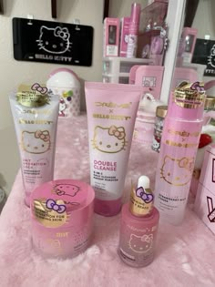 hello kitty products are displayed on a pink table