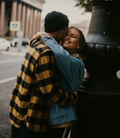 a man and woman embracing each other near a street light