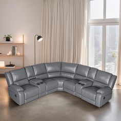 a large gray leather sectional sofa sitting in front of a window