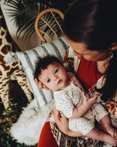 a woman holding a baby in her arms