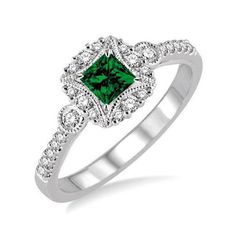 a white gold ring with an emerald and diamonds