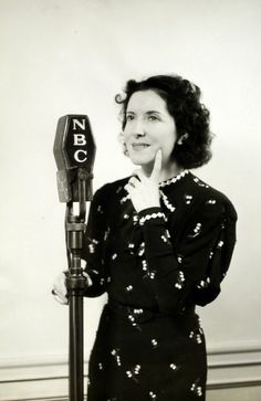 a woman standing next to a parking meter