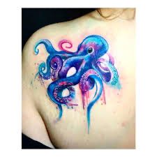 an octopus tattoo on the back of a woman's upper shoulder, with watercolor tattoos