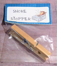 a small wooden stapler sitting on top of a plastic bag next to a sign that says snore stopper