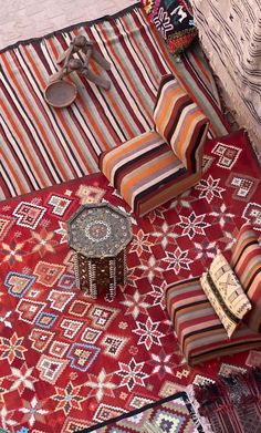 an assortment of colorful rugs and pillows on display