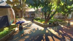 a woman with an umbrella walks down the street in front of some buildings and trees