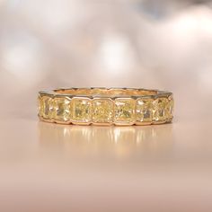 This impressive diamond band is made in 18k yellow gold with an eternity of fancy yellow diamonds. The diamonds weigh a total of approximately 5.16 carats with VS clarity. ✦ DIAMOND SPECIFICATIONS: Diamond Cut: Cushion Cut Diamond Weight 5.16 Carats Total ✦ ENGAGEMENT RING SPECIFICATIONS: Ring Material: Yellow Gold Stones: Diamond ✦ WHAT COMES IN YOUR SHIPMENT: - Your Engagement Ring - Quality Ring Box - Jewelry Cleaner - UGL Certificate ✦ WHY SHOP WITH US: - We've been in business for 40+ years Yellow Diamond Band Ring, Yellow Diamond Eternity Band, Yellow Diamond Band, Yellow Diamond Wedding Band, Estate Diamond Jewelry, Diamond Eternity Wedding Band, Half Bezel, Yellow Diamonds, Yellow Diamond Rings