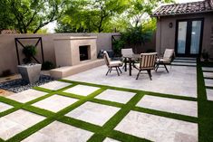 an outdoor patio with artificial grass on the ground