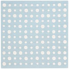 a blue rug with white polka dots on the top and bottom, along with a light blue background