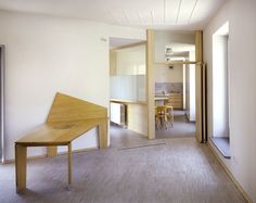 an empty room with a wooden table and chairs