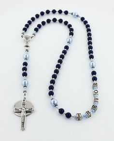 This First Communion Rosary is a handsome First Communion Gift. The personalized rosary is available with or without a Name in Beads and with or without an Engraved Disc. The Dark Blue & Light Blue Rosary is made with all Genuine Swarovski Pearls. It comes with your choice of a gift message that is elegantly boxed for simple gift giving. Add a Name in the 3rd Decade - Select a name option. - Enter a name that is 10 characters or less. Add an Engraved Disc - Select a Disc option. - Select a D Personalized Blue Round Beads Jewelry For Gift, Customizable Blue Jewelry For Mother's Day, Personalized Blue Beaded Jewelry, Blue Round Beads Jewelry For Personalized Gift, Blue Rosary, Personalized Rosary, First Communion Gifts, Simple Gift, Communion Gifts