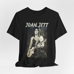 JOAN JETT T Shirt Tshirt T-shirt Tee Shirt Retro 1980s Style Band Tee Unisex Vintage Aesthetic Distressed This classic unisex jersey short sleeve tee fits like a well-loved favorite. Soft cotton and quality print make users fall in love with it over and over again. These t-shirts have-ribbed knit collars to bolster shaping. The shoulders have taping for better fit over time. Dual side seams hold the garment's shape for longer.  .: 100% Airlume combed and ringspun cotton (fiber content may vary for different colors) .: Light fabric (4.2 oz/yd² (142 g/m .: Retail fit .: Tear away label .: Runs true to size Joan Jett Jewelry, Retro Relaxed Fit T-shirt With Band Logo, Rock Band Logo T-shirt Relaxed Fit, Joan Jett Tshirt, Kittie Band Shirt, Joan Jett Performing, Band T Shirts, Joan Jett, 1980s Fashion